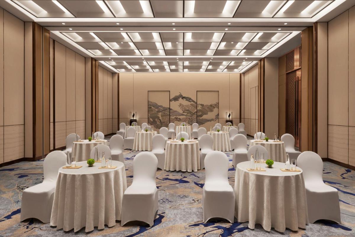 a ballroom with tables and chairs in a room with a ballroom at JW Marriott Mumbai Juhu in Mumbai