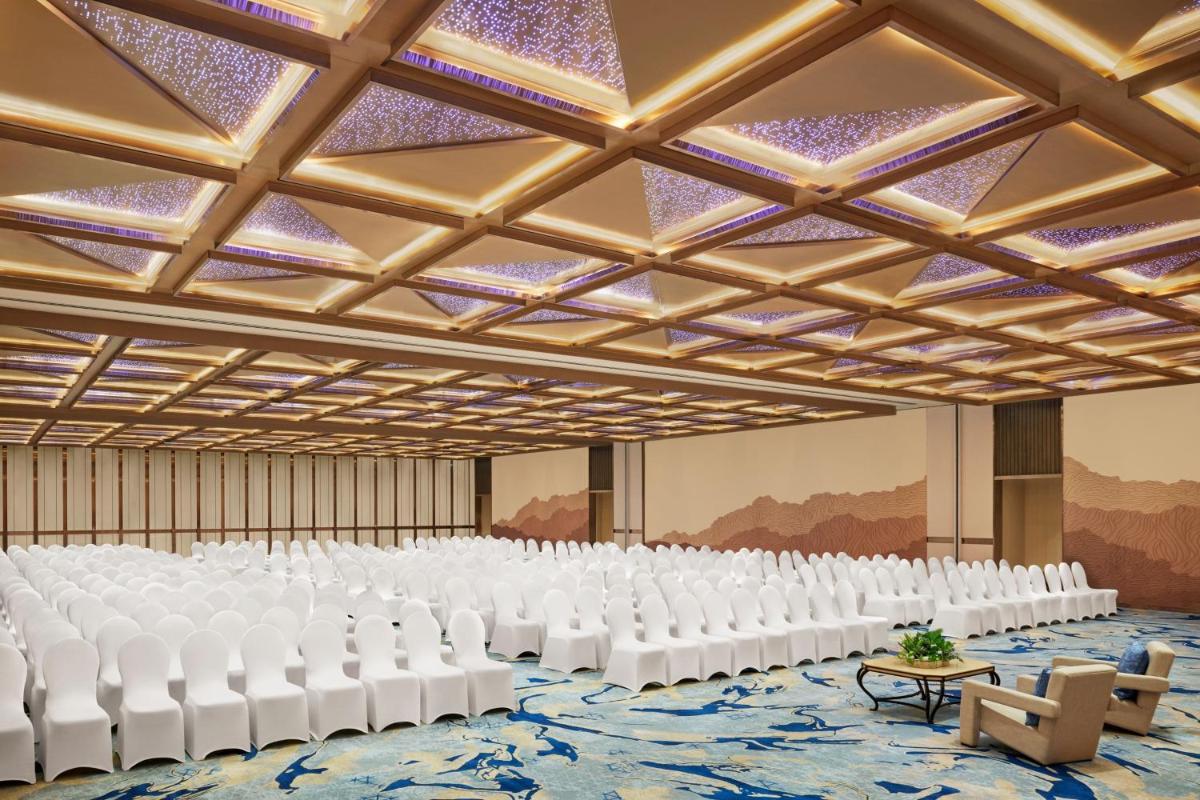 an empty hall with white chairs and tables at JW Marriott Mumbai Juhu in Mumbai