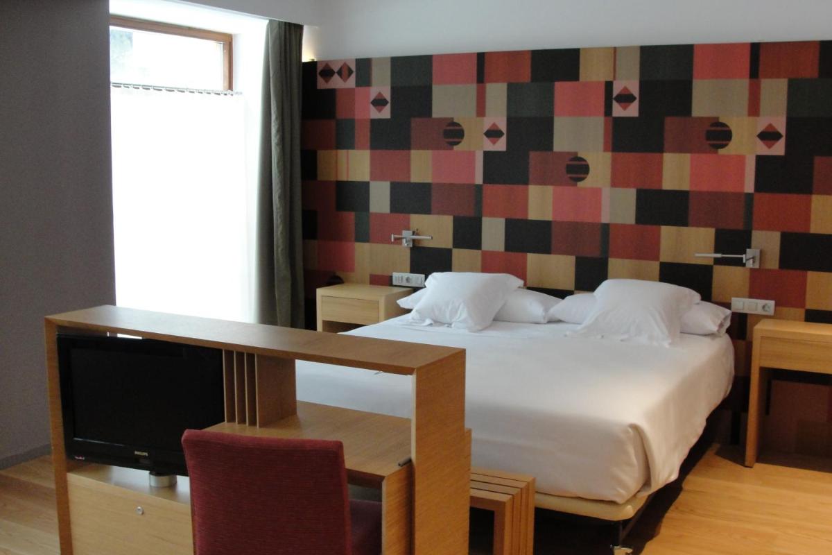Cama o camas de una habitación en Hotel Continental Balneario de Panticosa