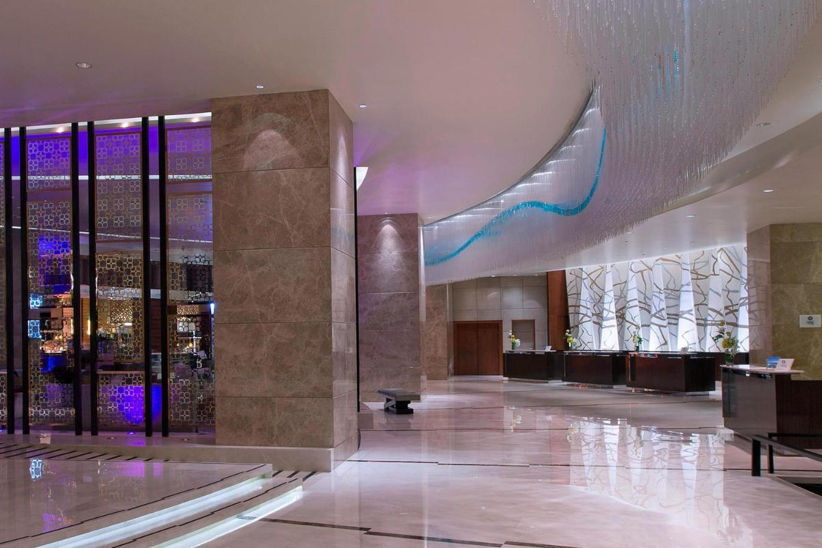 a lobby of a building with a large building at Sheraton Grand Bangalore Hotel at Brigade Gateway in Bengaluru
