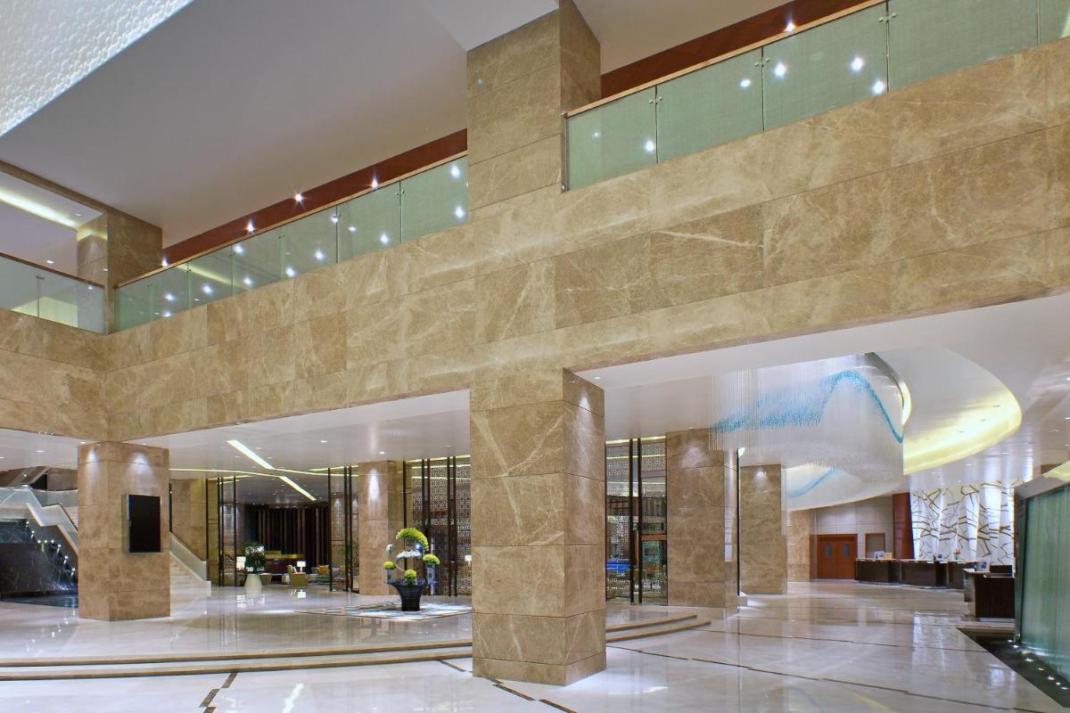 a lobby of a hotel with a large building at Sheraton Grand Bangalore Hotel at Brigade Gateway in Bengaluru
