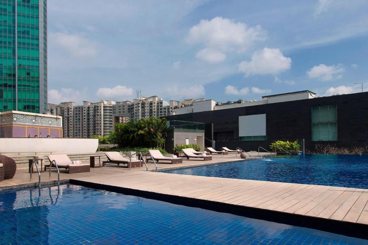 a swimming pool on top of a building at Sheraton Grand Bangalore Hotel at Brigade Gateway in Bengaluru a swimming pool on top of a building at Sheraton Grand Bangalore Hotel at Brigade Gateway in Bengaluru