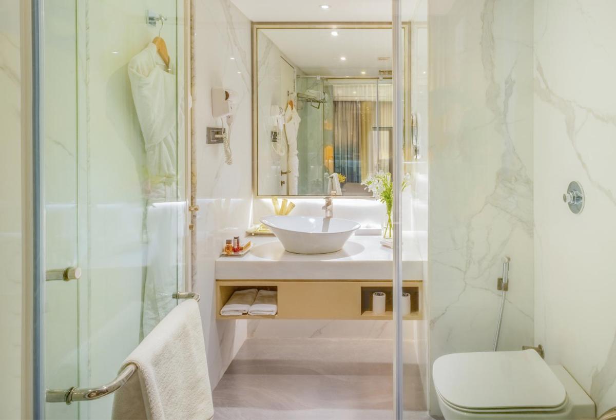a bathroom with a sink and a shower at Sayaji Pune in Pune