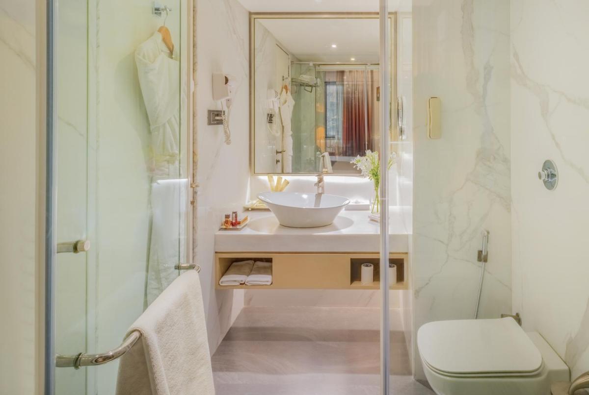 a bathroom with a sink and a shower at Sayaji Pune in Pune