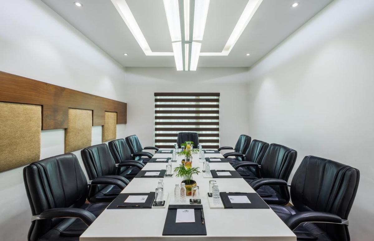 a large conference room with a long table and chairs at Sayaji Pune in Pune