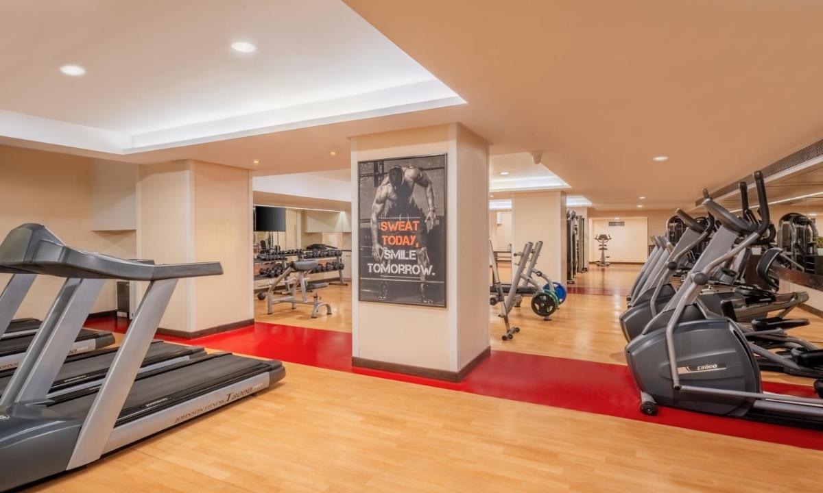 a gym with treadmills and elliptical machines at Sayaji Pune in Pune