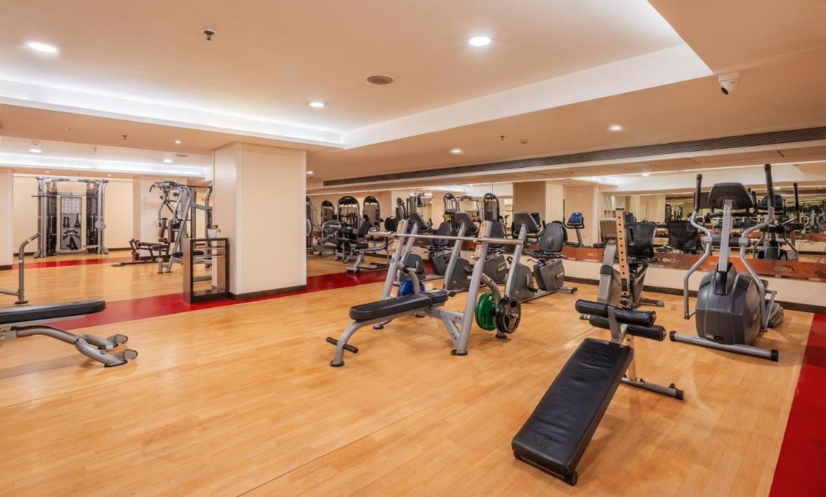 a gym with treadmills and elliptical machines at Sayaji Pune in Pune