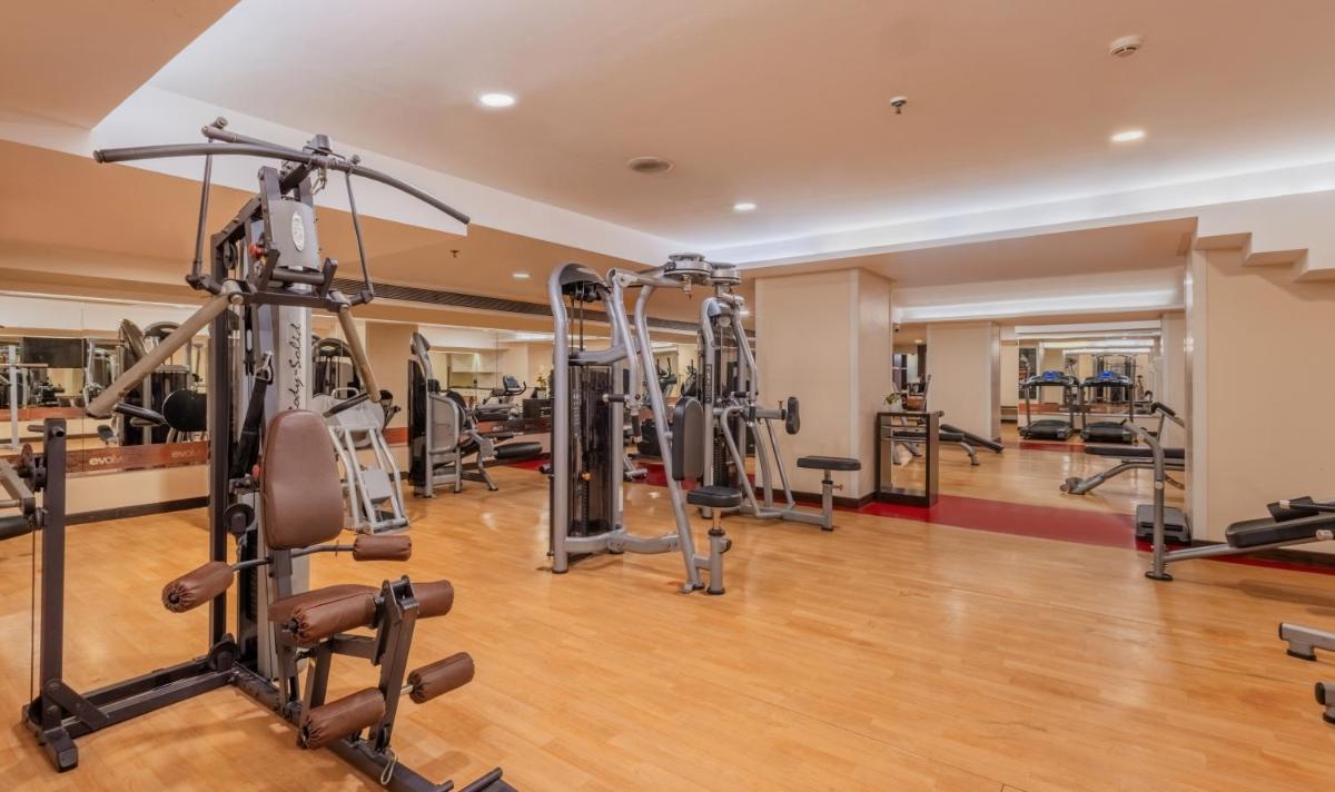 a gym with several treadmills and machines at Sayaji Pune in Pune