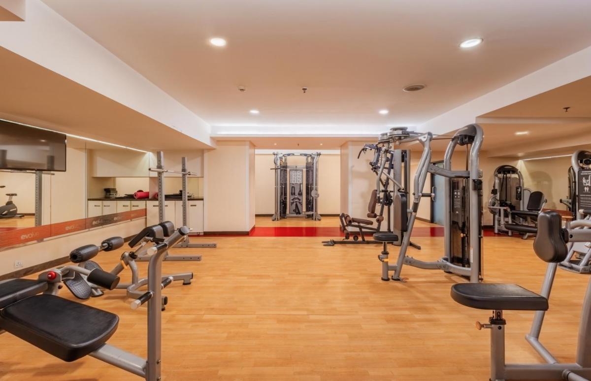 a gym with treadmills and cardio equipment in a building at Sayaji Pune in Pune