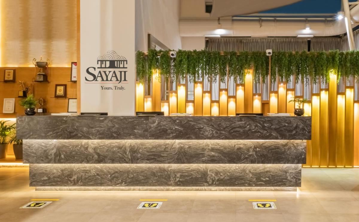a lobby with a bunch of candles in a building at Sayaji Pune in Pune