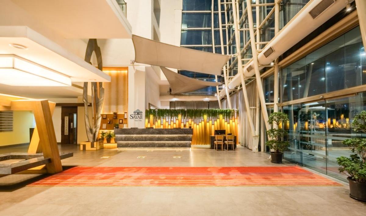a lobby with a couch in a building at Sayaji Pune in Pune