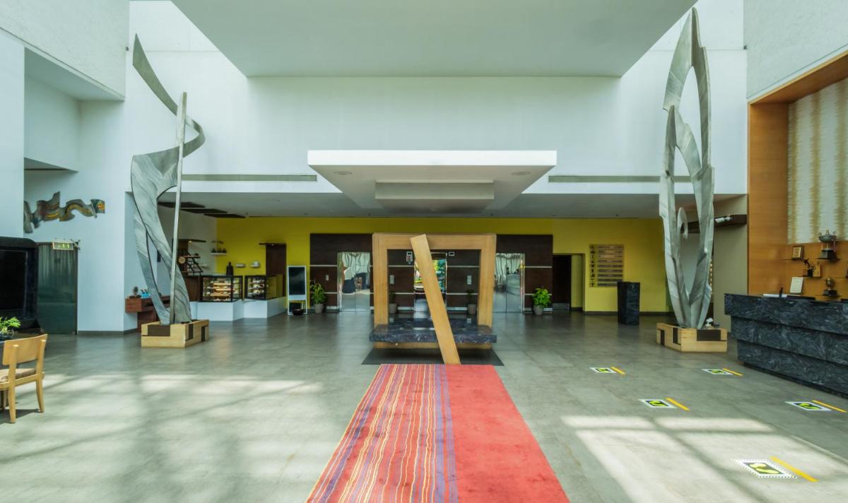 a lobby with a red carpet in a building at Sayaji Pune in Pune