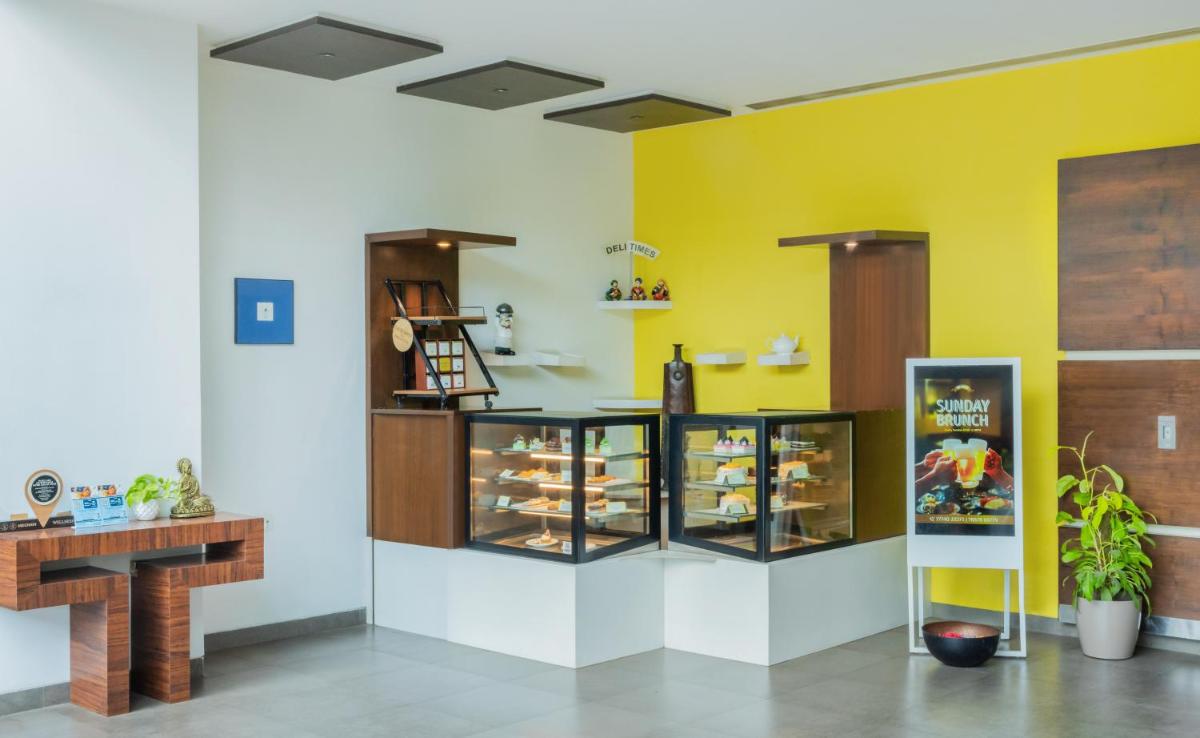 a room with a bakery with yellow walls at Sayaji Pune in Pune
