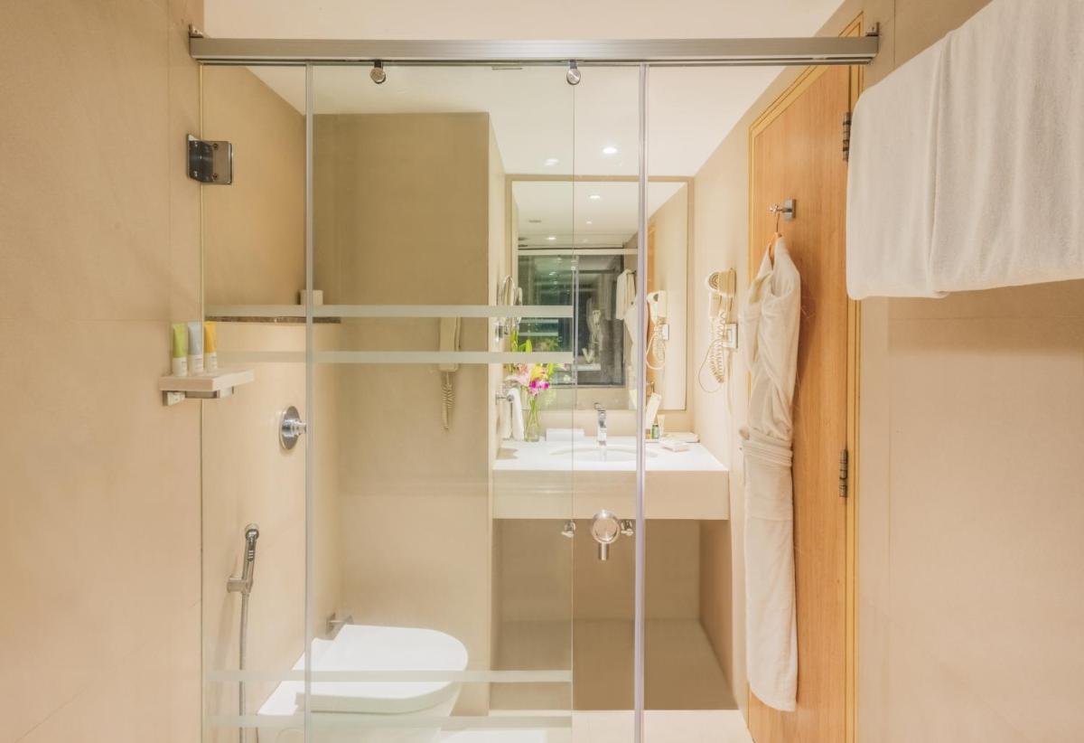 a bathroom with a shower and a toilet and a sink at Sayaji Pune in Pune