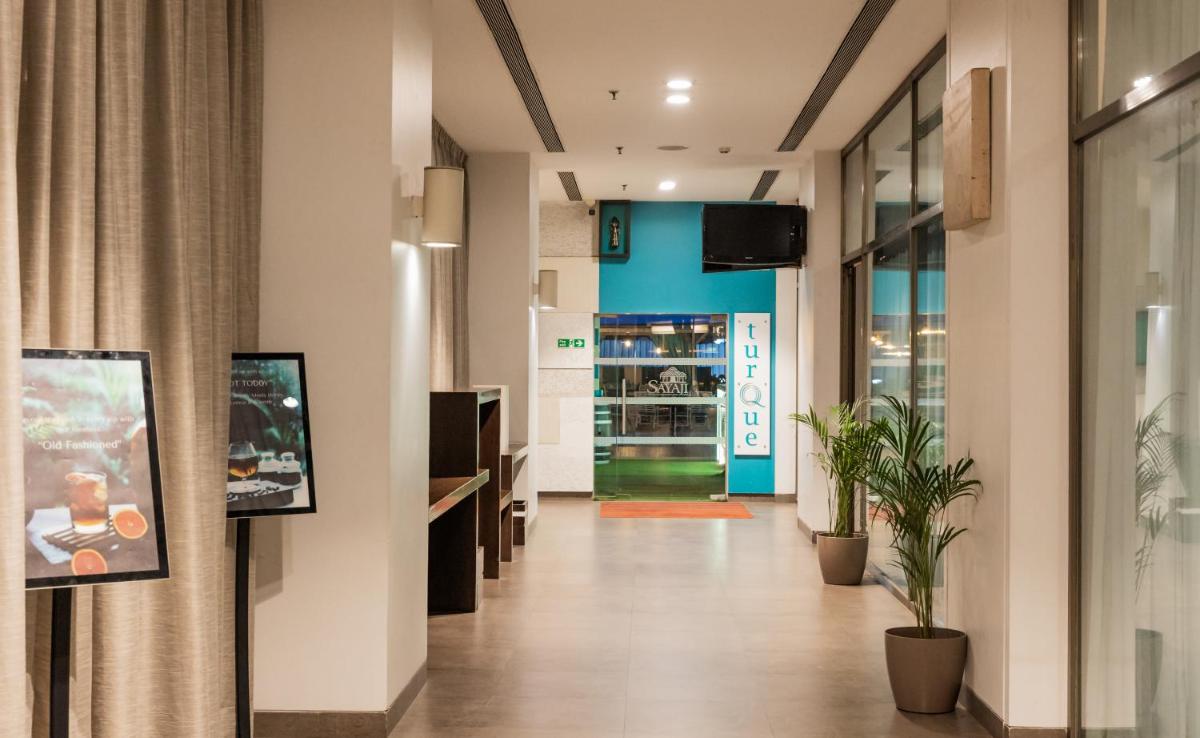 a hallway of a store with a door and a plant at Sayaji Pune in Pune