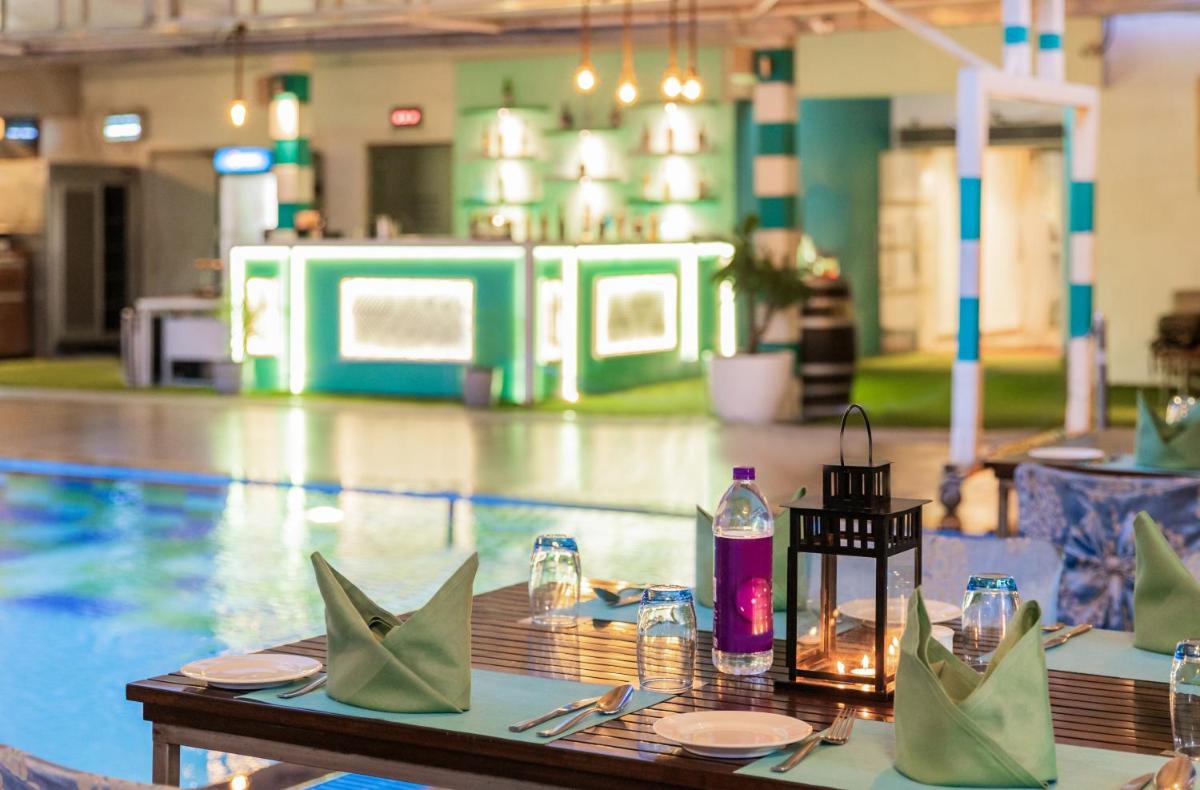 a table with napkins and a bottle on top of a pool at Sayaji Pune in Pune