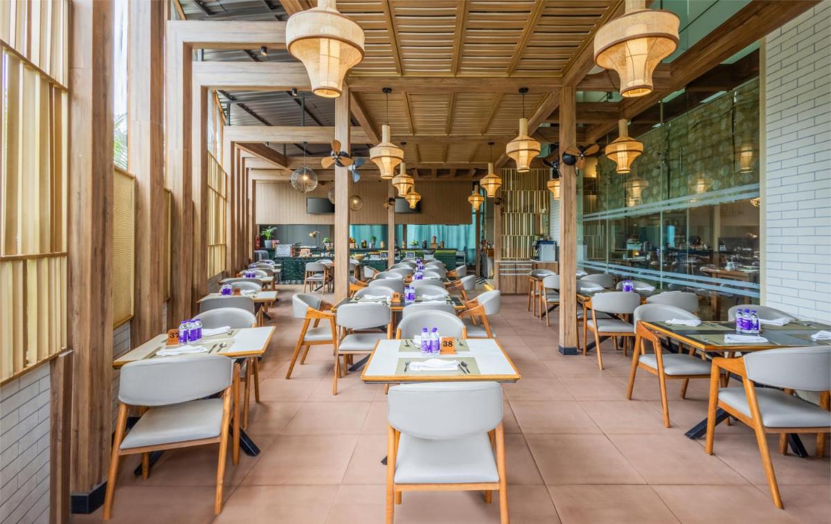 a row of tables and chairs in a restaurant at Sayaji Pune in Pune