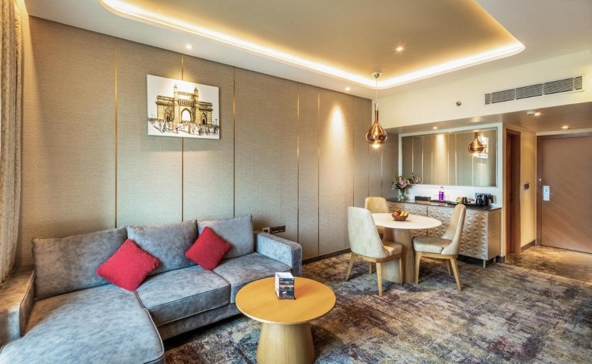 a living room with a couch and a table at Sayaji Pune in Pune