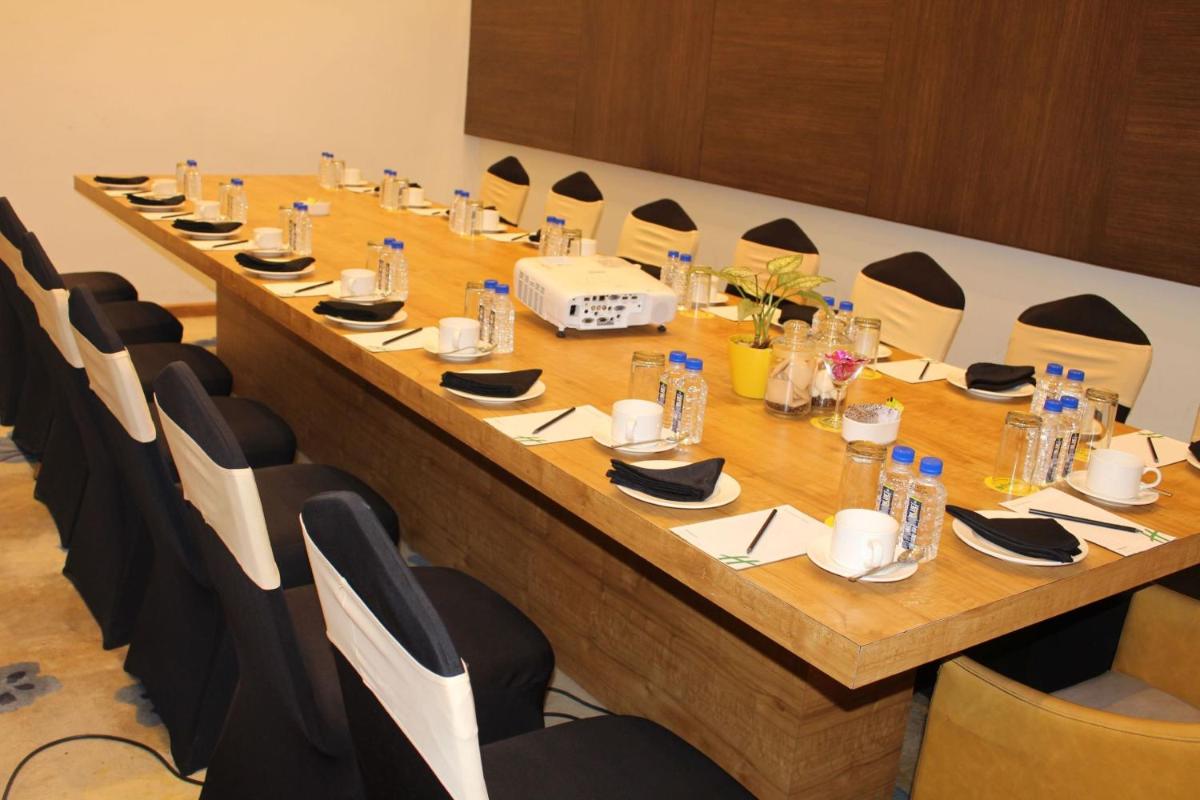 a long table in a room with chairs at Holiday Inn Kolkata Airport by IHG in Kolkata