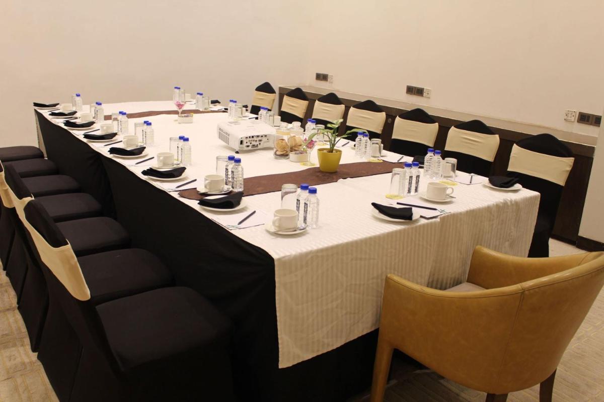 a long table in a room with chairs at Holiday Inn Kolkata Airport by IHG in Kolkata