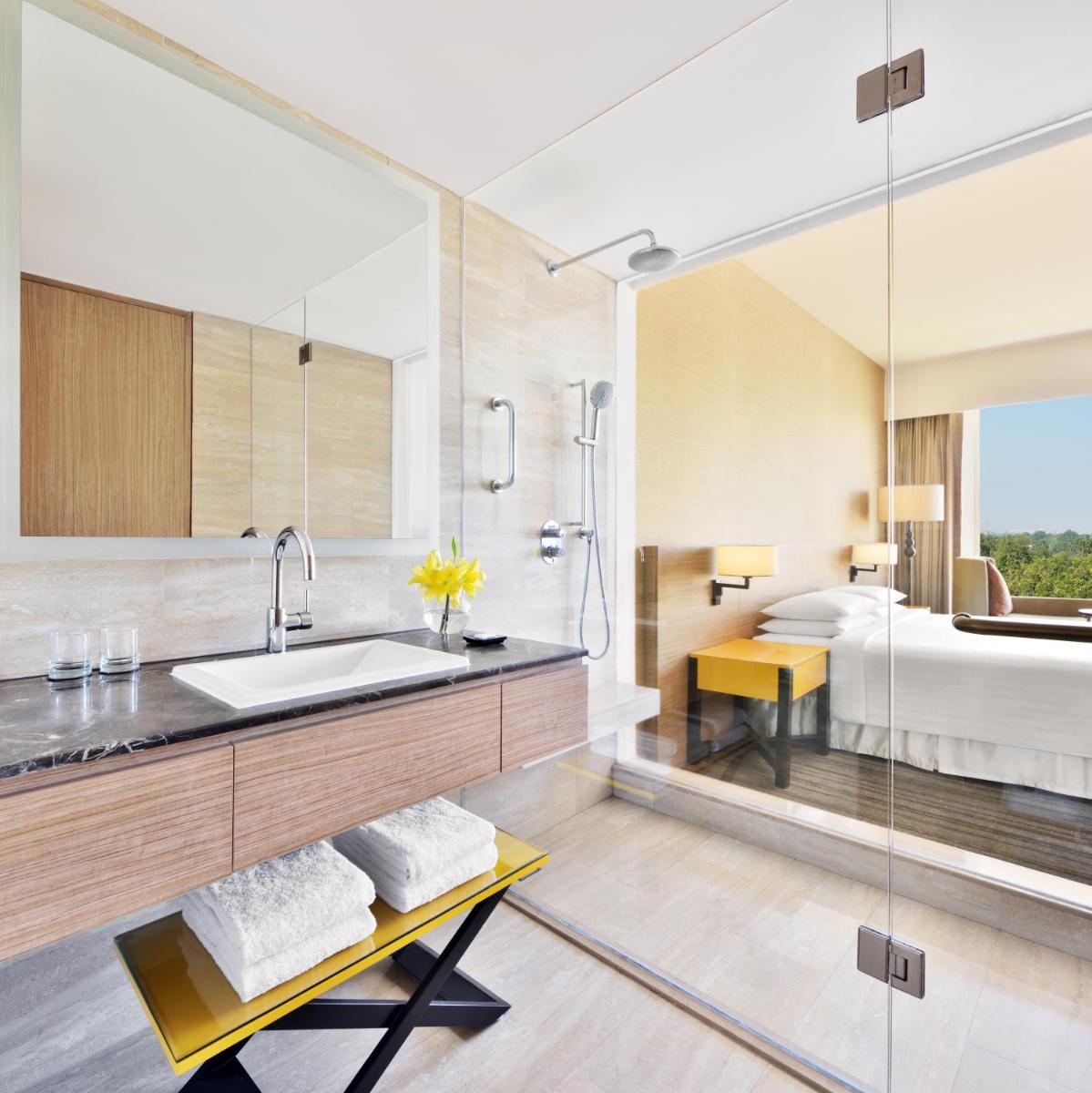 a bathroom with a sink and a bed at Courtyard by Marriott Bengaluru Outer Ring Road in Bengaluru a bathroom with a sink and a bed at Courtyard by Marriott Bengaluru Outer Ring Road in Bengaluru