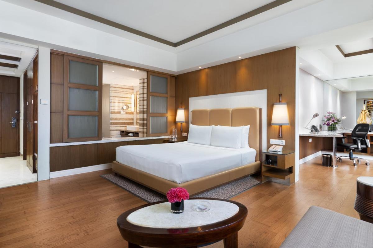 a hotel room with a bed and a table at Crowne Plaza New Delhi Okhla by IHG in New Delhi