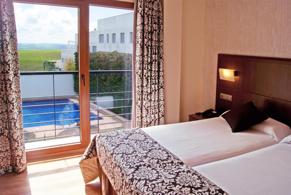 Cama o camas de una habitación en Hotel Andalussia