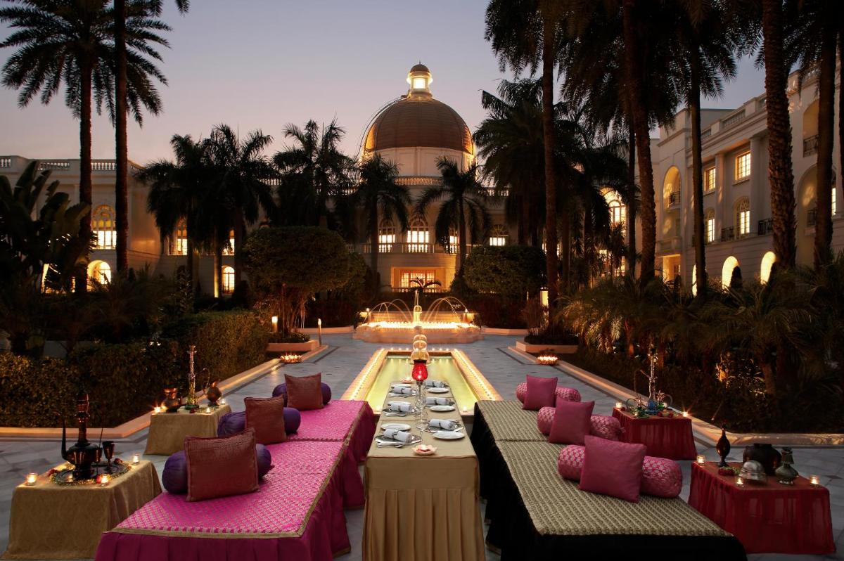 a hotel with tables with plates of food in front of a building at Taj Mahal Lucknow in Lucknow +18 photos