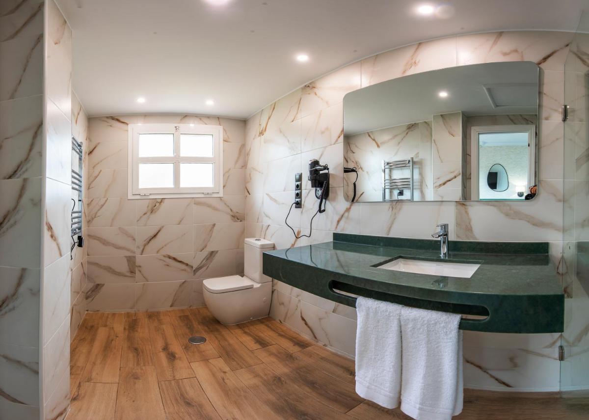 un baño con lavabo y espejo en Hotel Tamisa Golf, en Mijas
