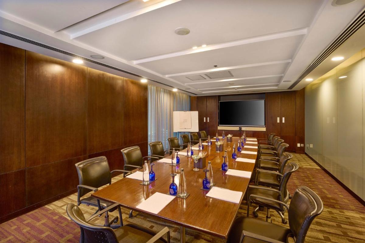 a conference room with a long table and chairs at Crowne Plaza Kochi by IHG in Cochin