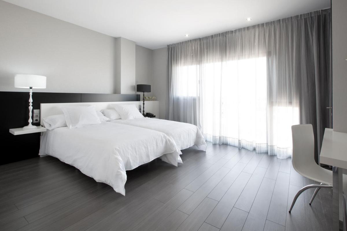 Cama o camas de una habitación en Hotel MasMonzon