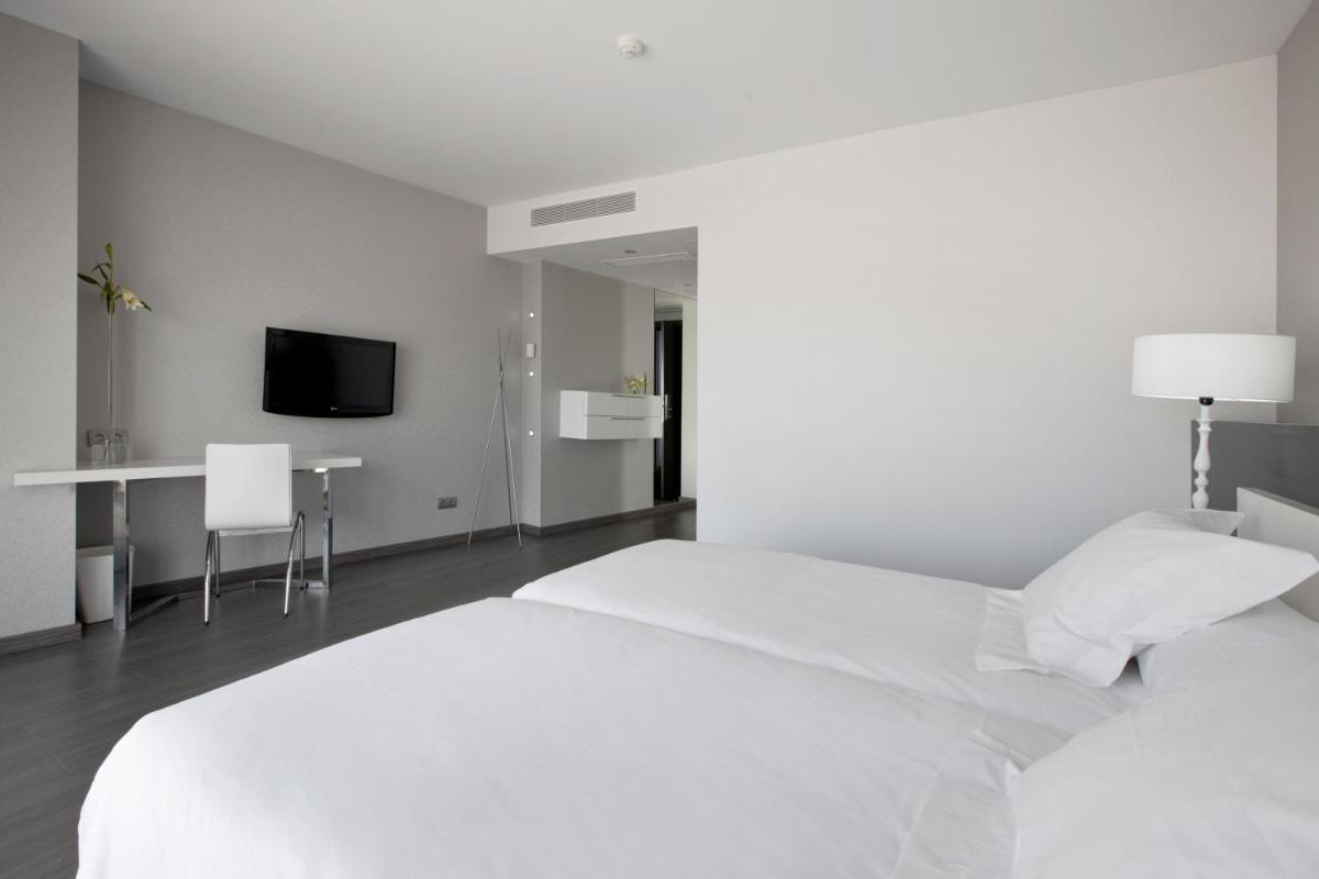 Cama o camas de una habitación en Hotel MasMonzon