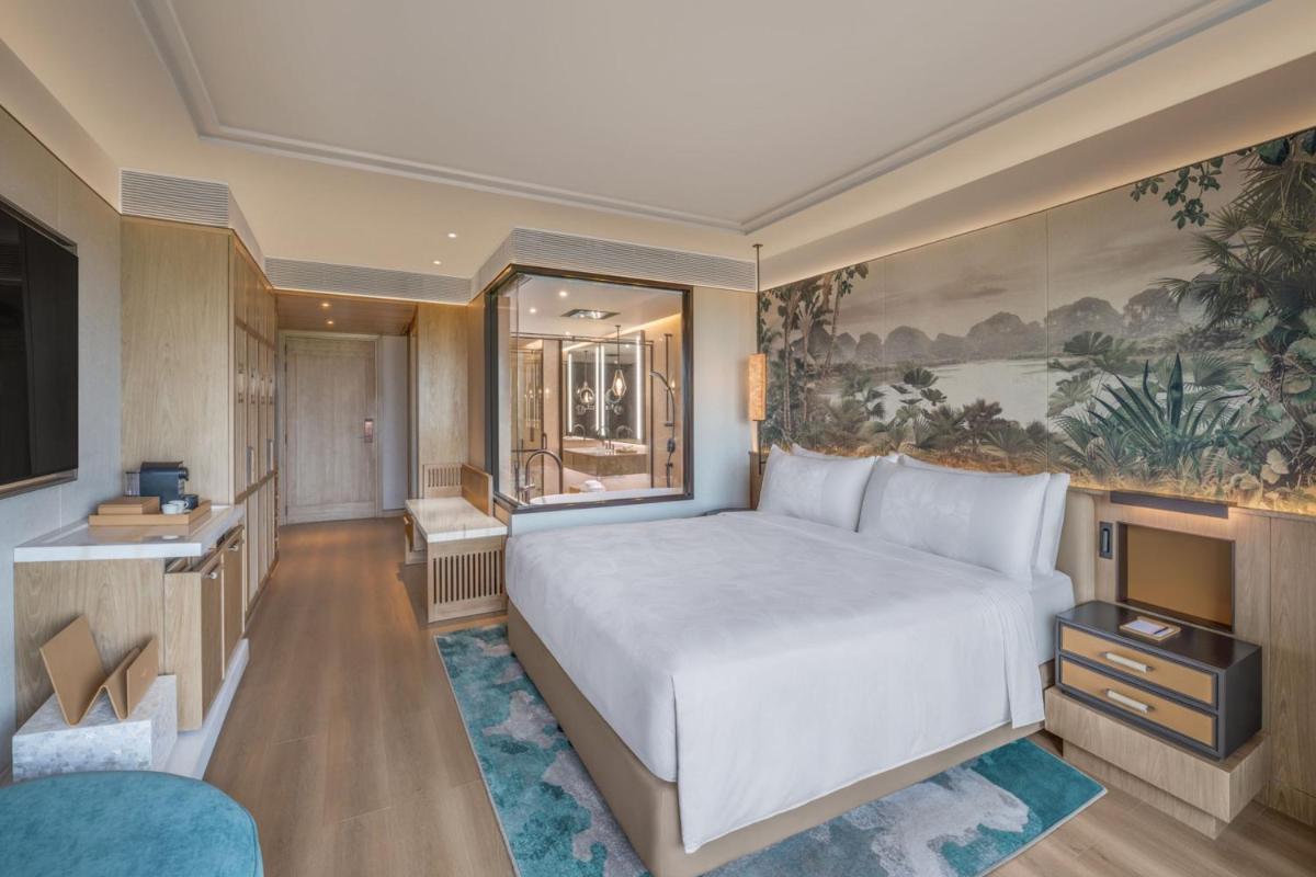 a bedroom with a large bed and a tv at JW Marriott Goa in Vagator a bedroom with a large bed and a tv at JW Marriott Goa in Vagator