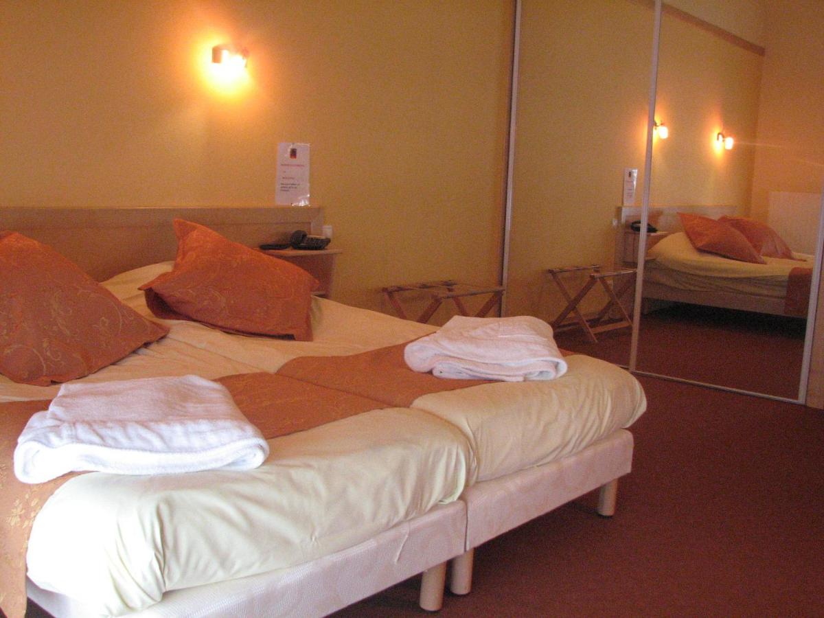Un ou plusieurs lits dans un hébergement de l'établissement Logis Hôtel Restaurant De La Poste et SPA de Montagne