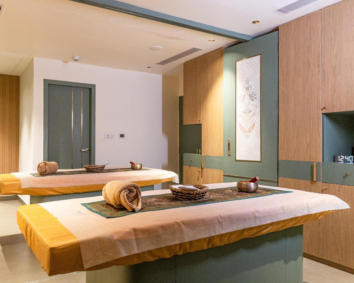 a room with two beds with bowls on a table at Holiday Inn Chennai OMR IT Expressway by IHG in Chennai