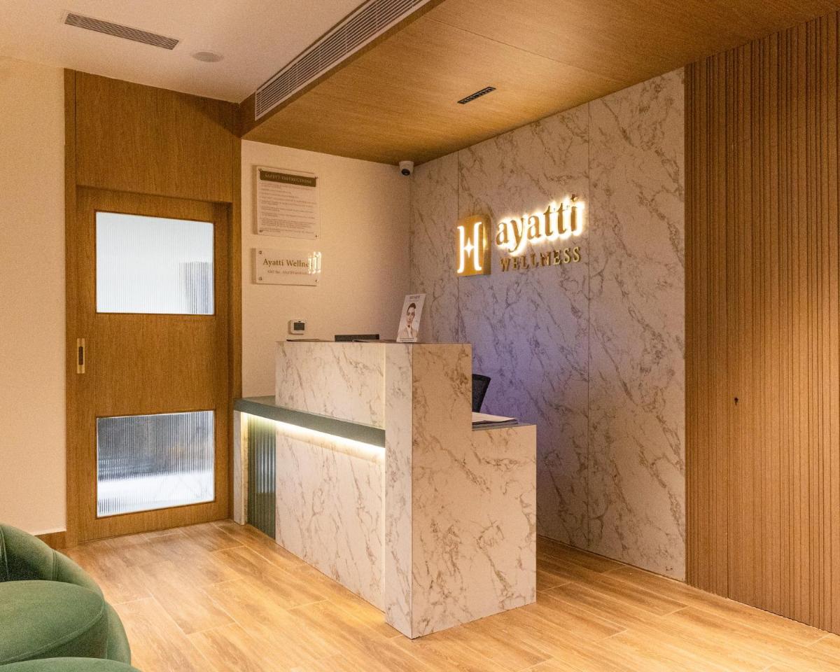 a lobby with a counter and a sign on a wall at Holiday Inn Chennai OMR IT Expressway by IHG in Chennai