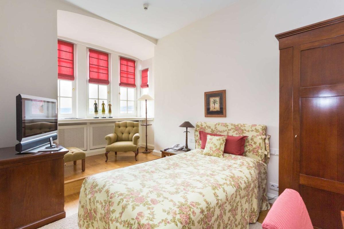 Ein Bett oder Betten in einem Zimmer der Unterkunft Schlosshotel Münchhausen