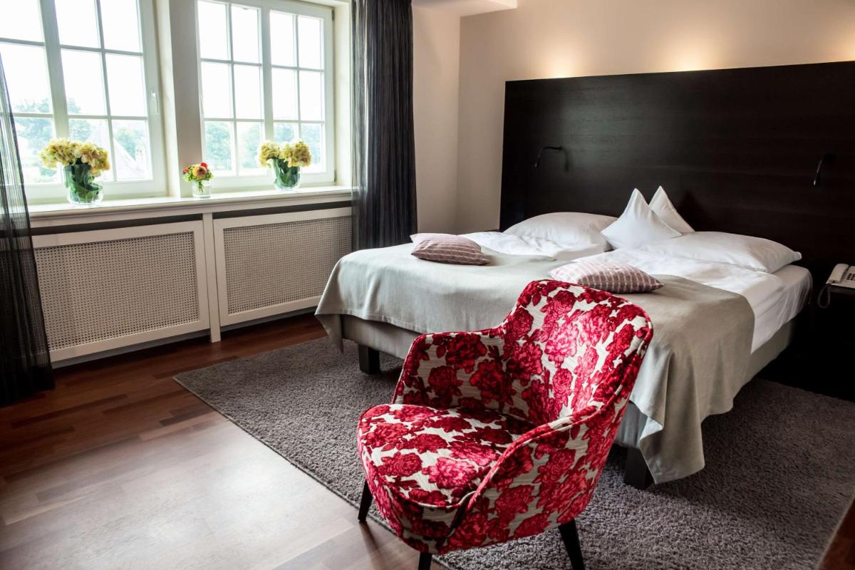Ein Bett oder Betten in einem Zimmer der Unterkunft Schlosshotel Münchhausen