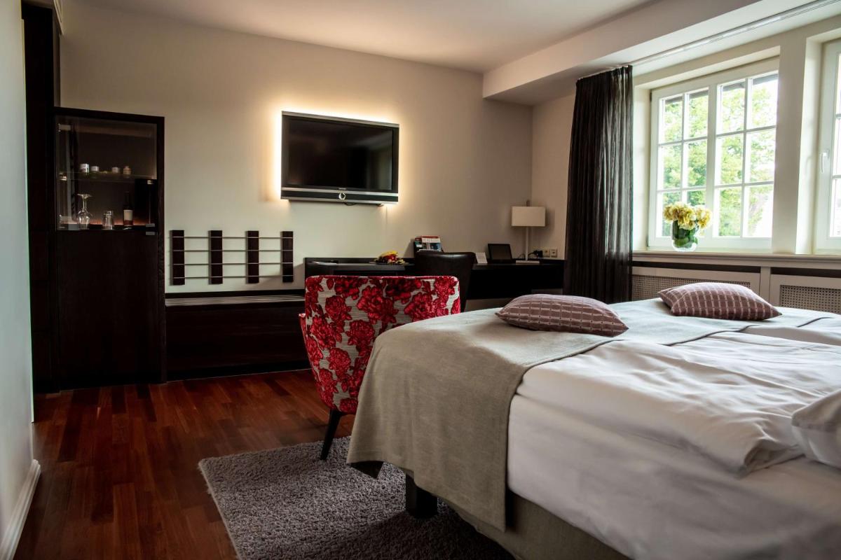 Ein Bett oder Betten in einem Zimmer der Unterkunft Schlosshotel Münchhausen