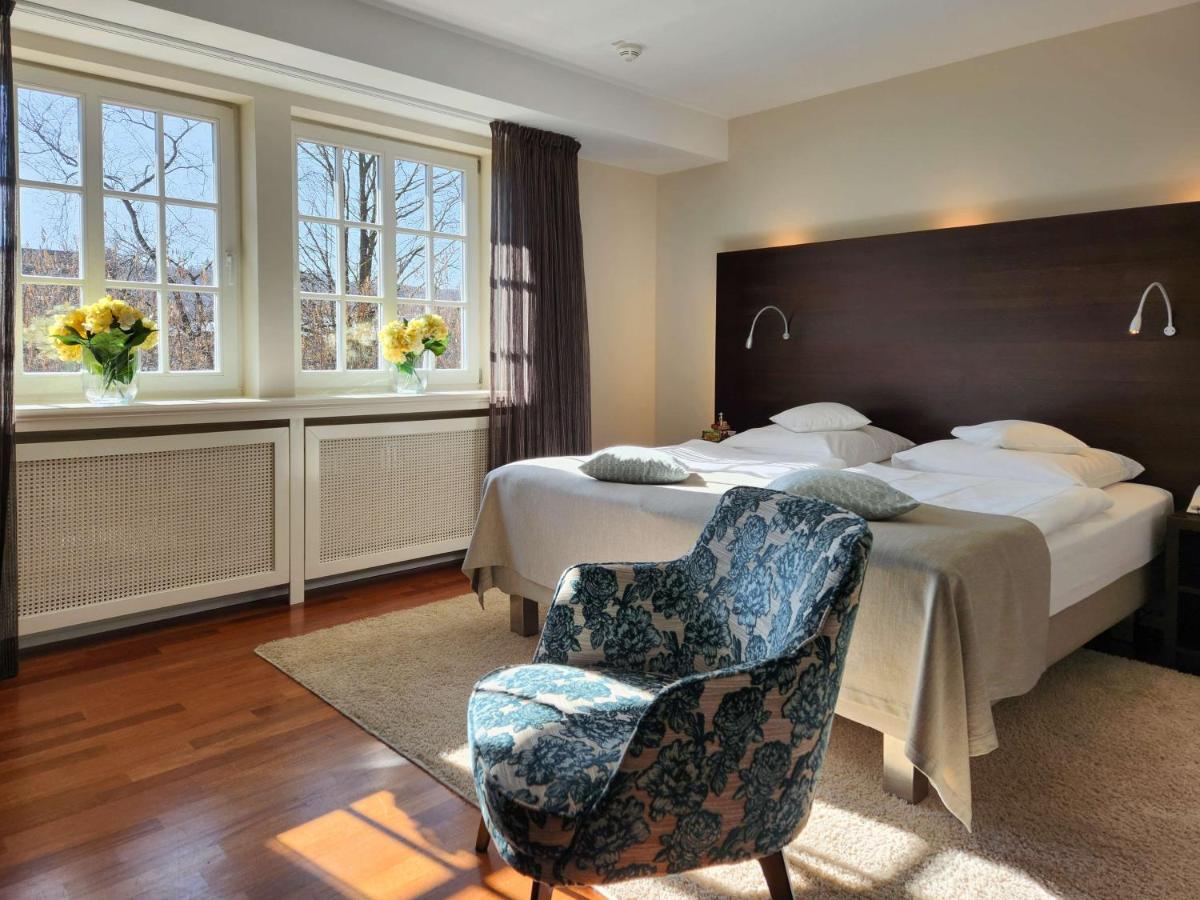 Ein Bett oder Betten in einem Zimmer der Unterkunft Schlosshotel Münchhausen