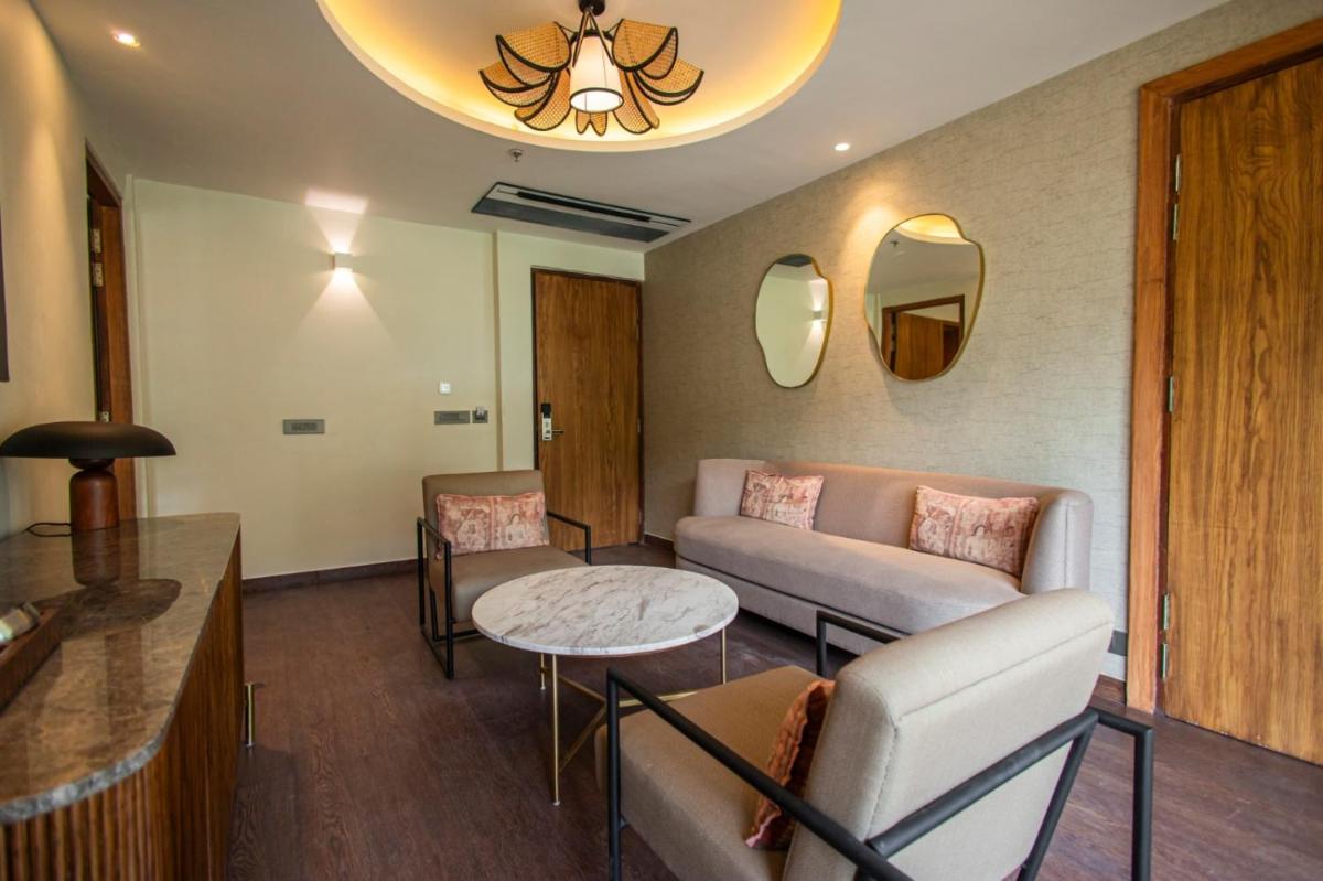 a living room with a couch and a table at Antalya By Divine Ganga Cottage in Rishīkesh