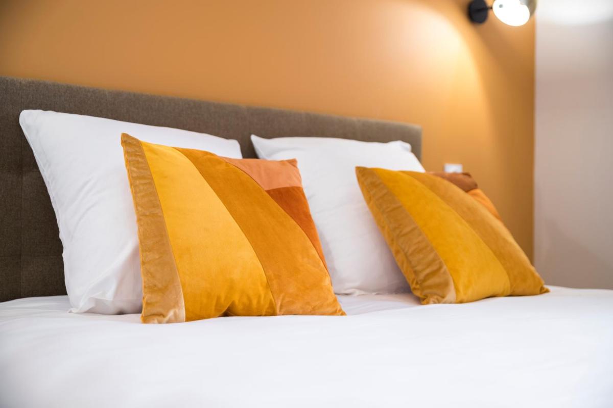 Un ou plusieurs lits dans un hébergement de l'établissement Hotel Clos Castel Villas Spa