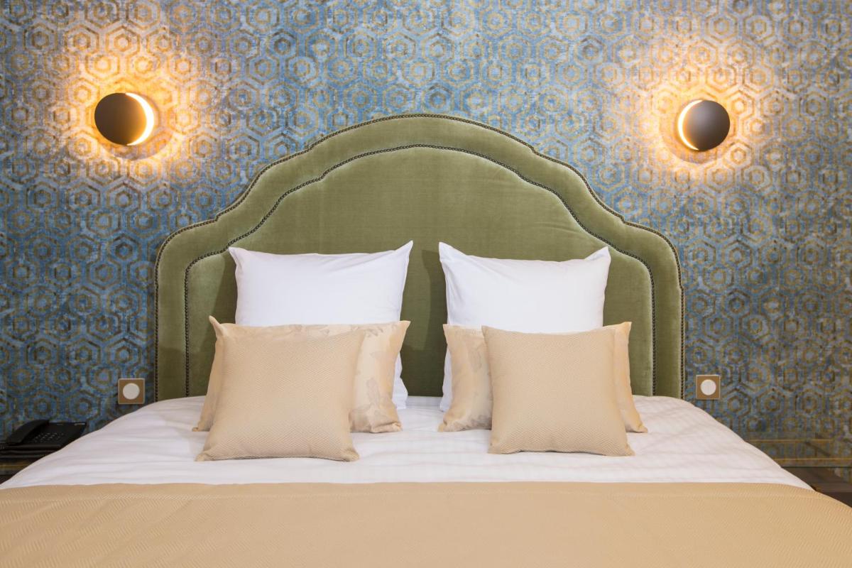 Un ou plusieurs lits dans un hébergement de l'établissement Hotel Clos Castel Villas Spa