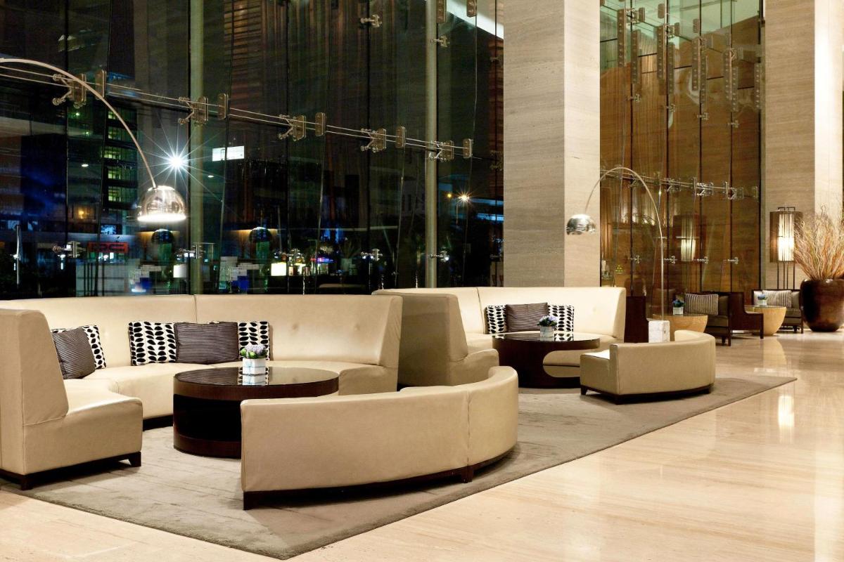 a lobby with couches and tables in a building at The Westin Gurgaon, New Delhi in Gurgaon