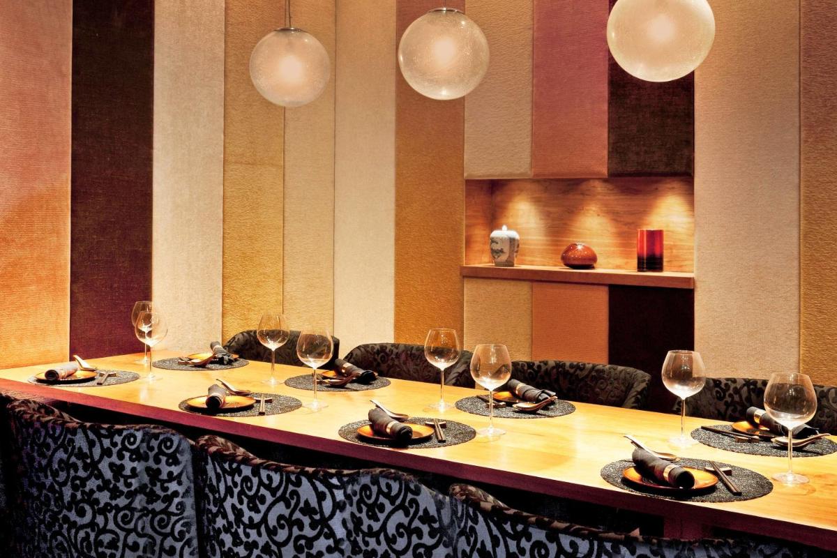 a table with chairs and wine glasses on it at The Westin Gurgaon, New Delhi in Gurgaon