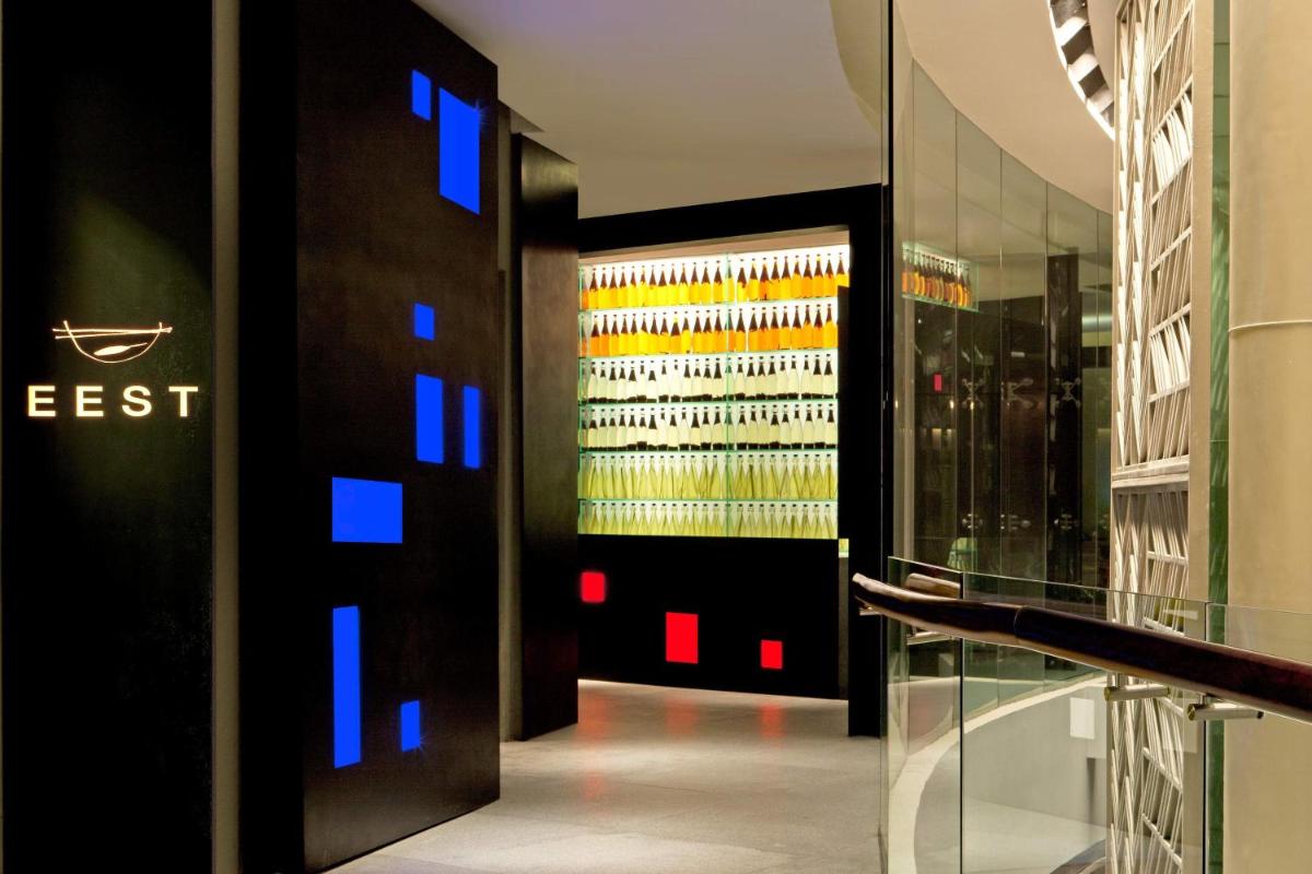 a room with a bunch of wine bottles in a wall at The Westin Gurgaon, New Delhi in Gurgaon
