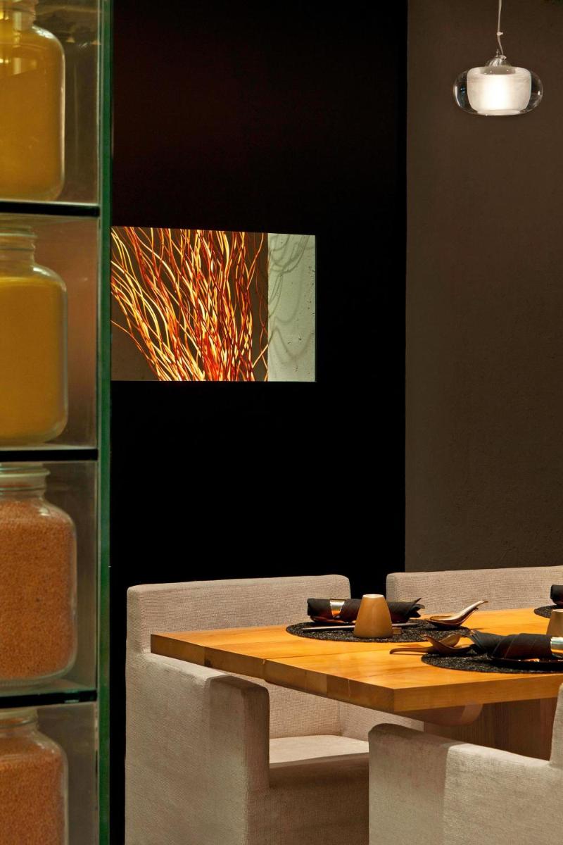 a dining room with a table and a painting on the wall at The Westin Gurgaon, New Delhi in Gurgaon