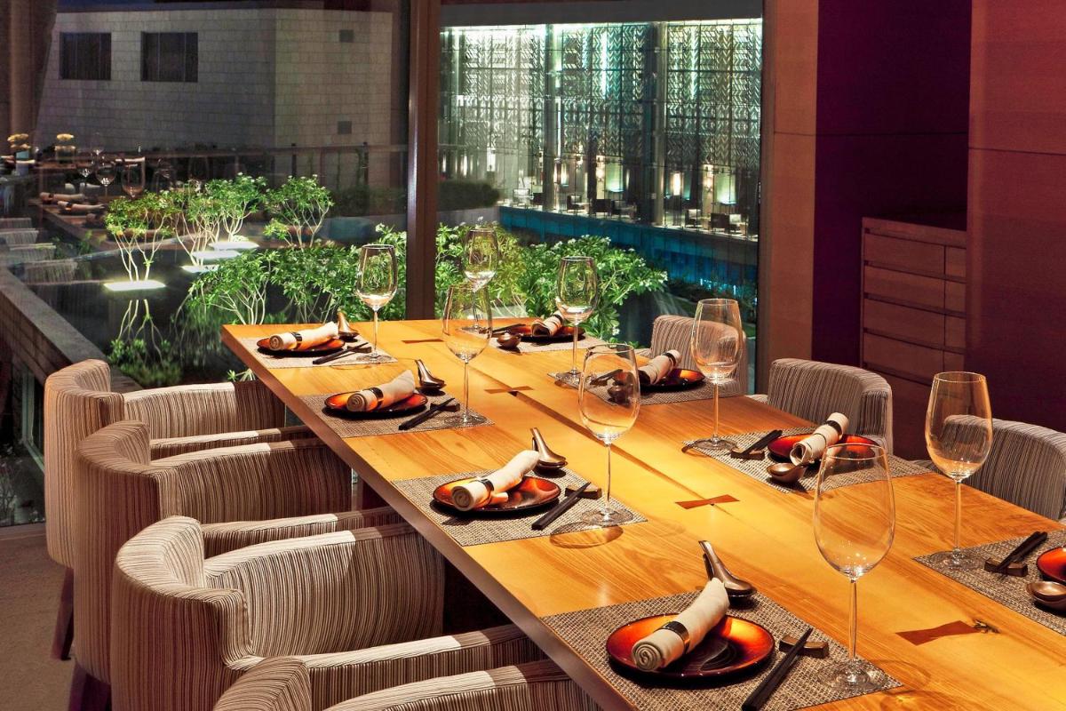 a long table in a restaurant with glasses on it at The Westin Gurgaon, New Delhi in Gurgaon