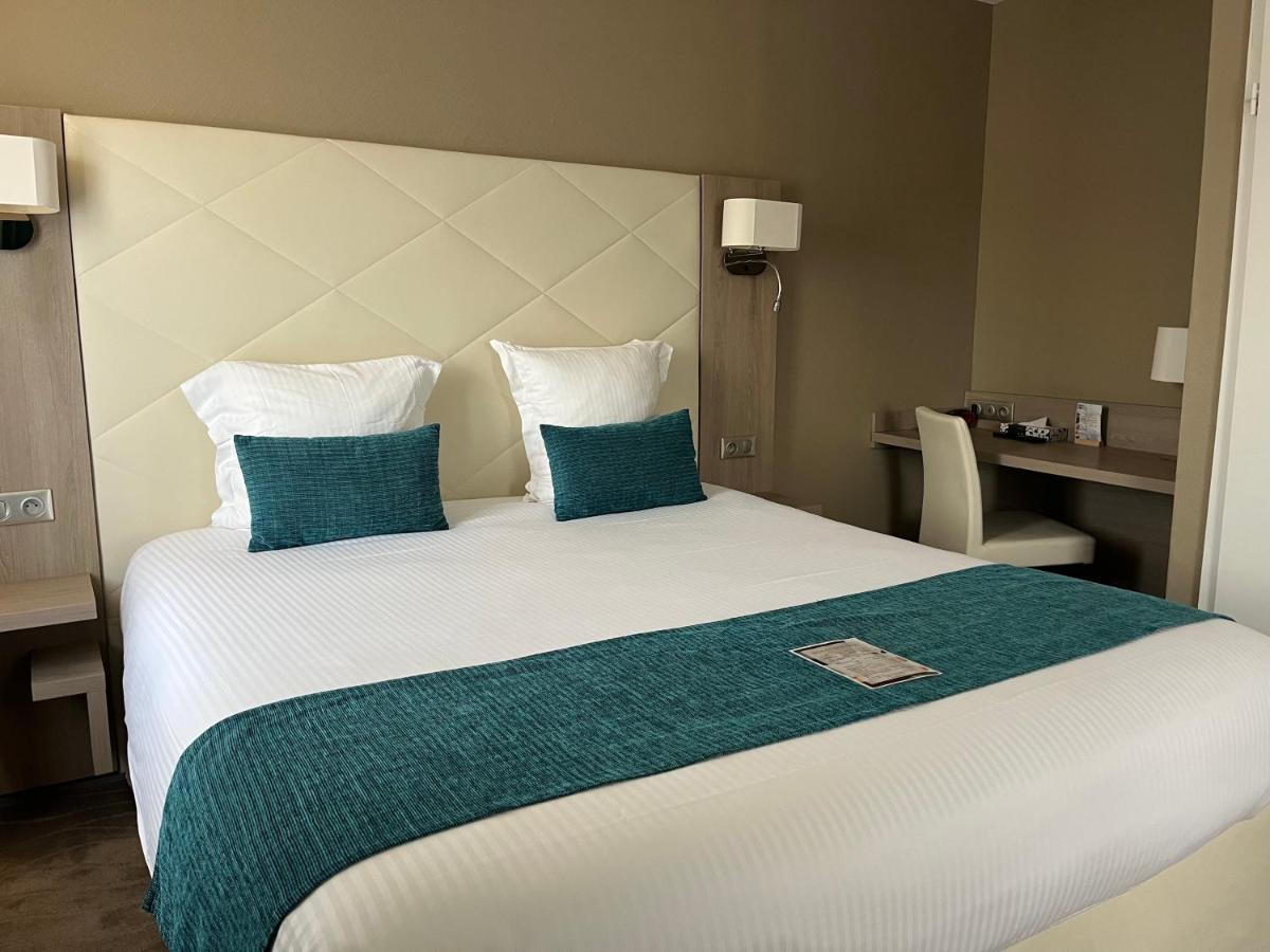 Un ou plusieurs lits dans un hébergement de l'établissement Hotel Normandy