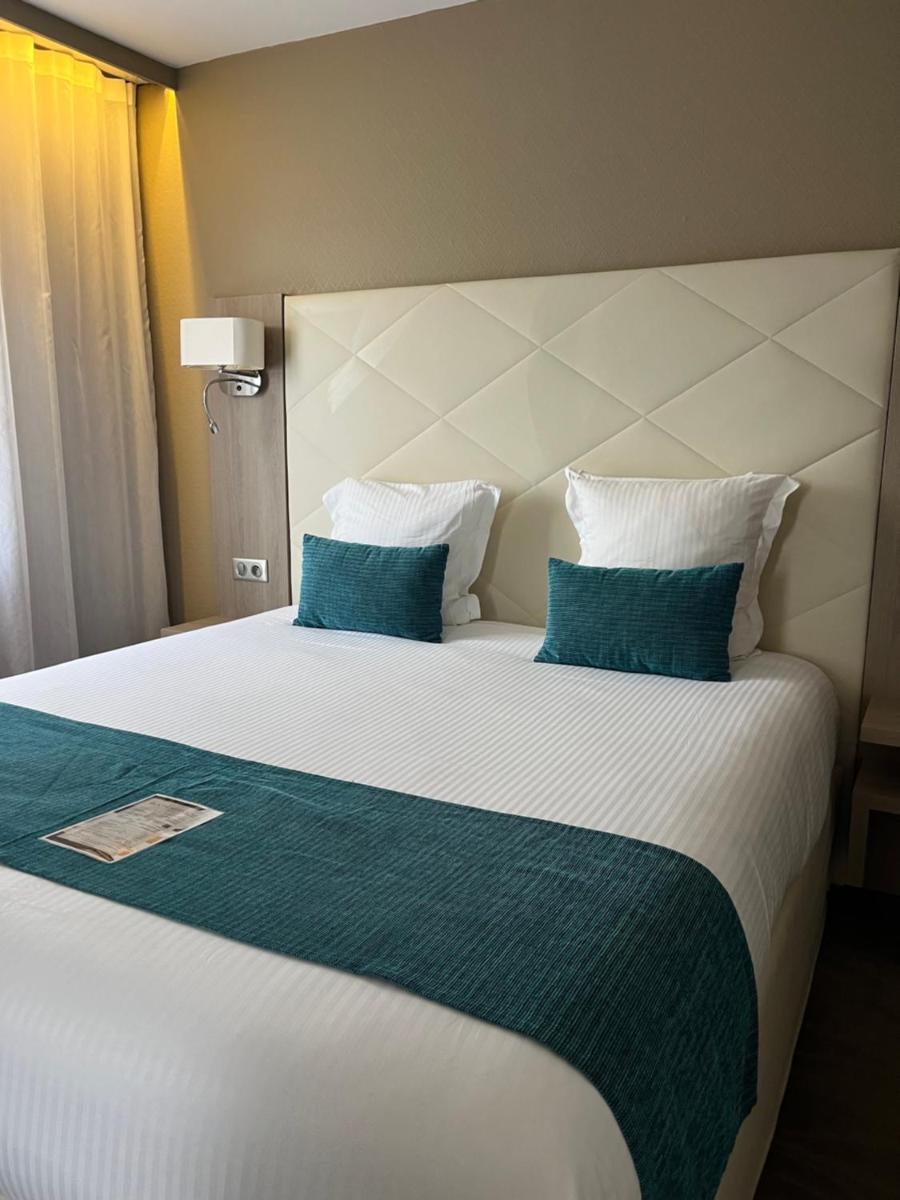 Un ou plusieurs lits dans un hébergement de l'établissement Hotel Normandy